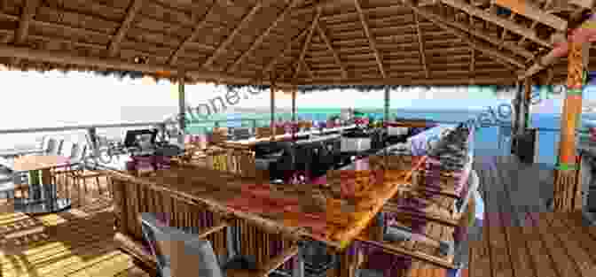 A Photo Of The Beach Bar Today, With A Large Deck, A Thatched Roof, And Plenty Of Seating. Rum Point Home Of The Mudslide : 50 Years Of History From Grand Caymans Favourite Beach Bar